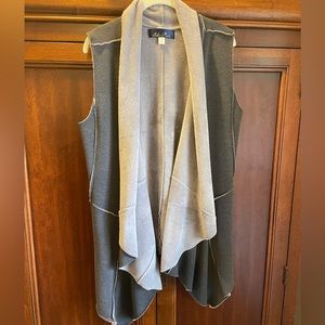 Cozy fleece vest, dark grey exterior, light grey fleece. Has pockets.